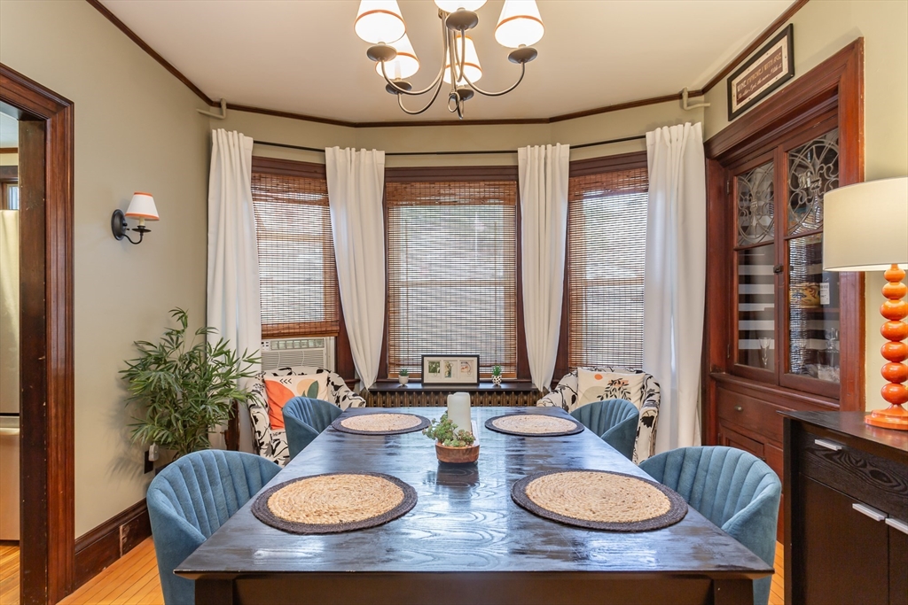 256 Maple Street Fall River, MA 02720 - Photo 6 of 41 a view of a dining room with furniture a chandelier and wooden floor