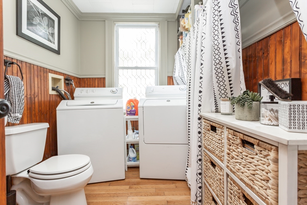 256 Maple Street Fall River, MA 02720 - Photo 9 of 41 a white toilet sitting next to a sink a washer and a window