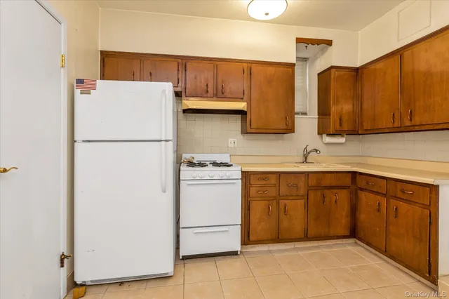 a kitchen with a refrigerator sink stove and cabinets