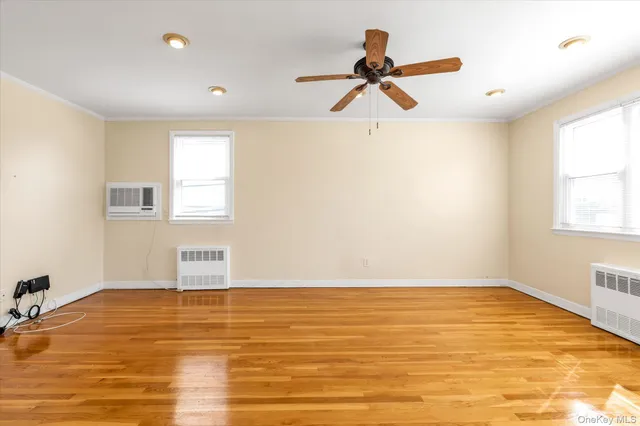 a view of a room with wooden floor and a window