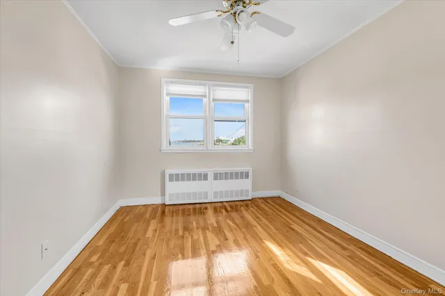 a view of a room with a window and a ceiling fan
