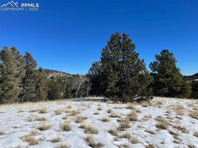 a view of a snow covered with snow in the background