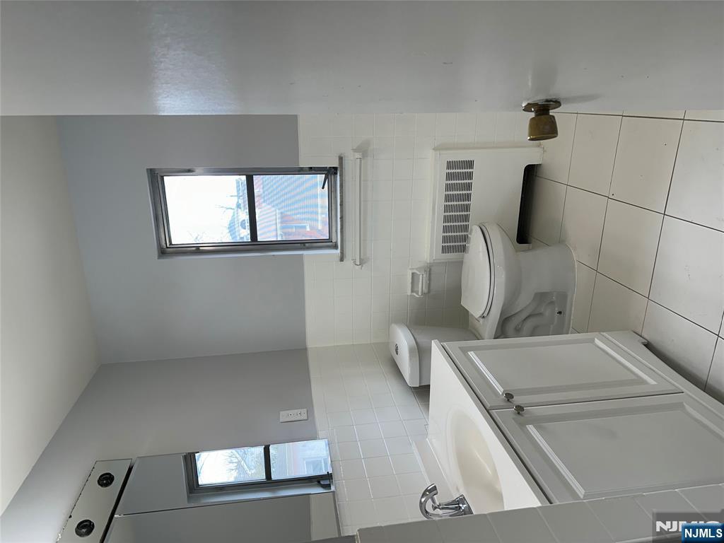 1032 Glen Road Fort Lee, NJ 07024 - Photo 12 of 16 a bathroom with a toilet sink and mirror