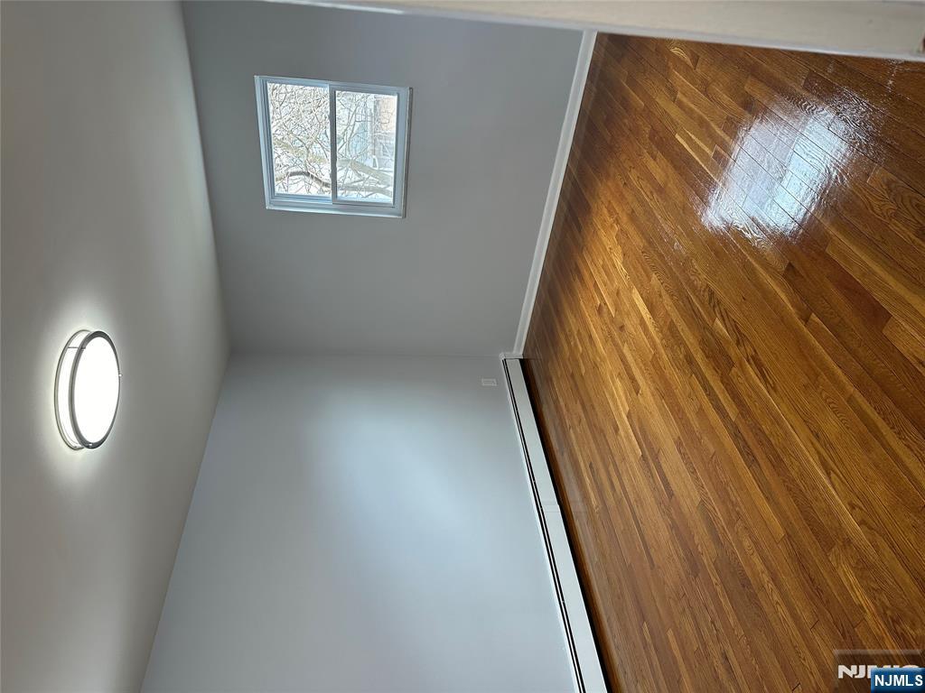 1032 Glen Road Fort Lee, NJ 07024 - Photo 13 of 16 a view of a room with wooden floor and white walls