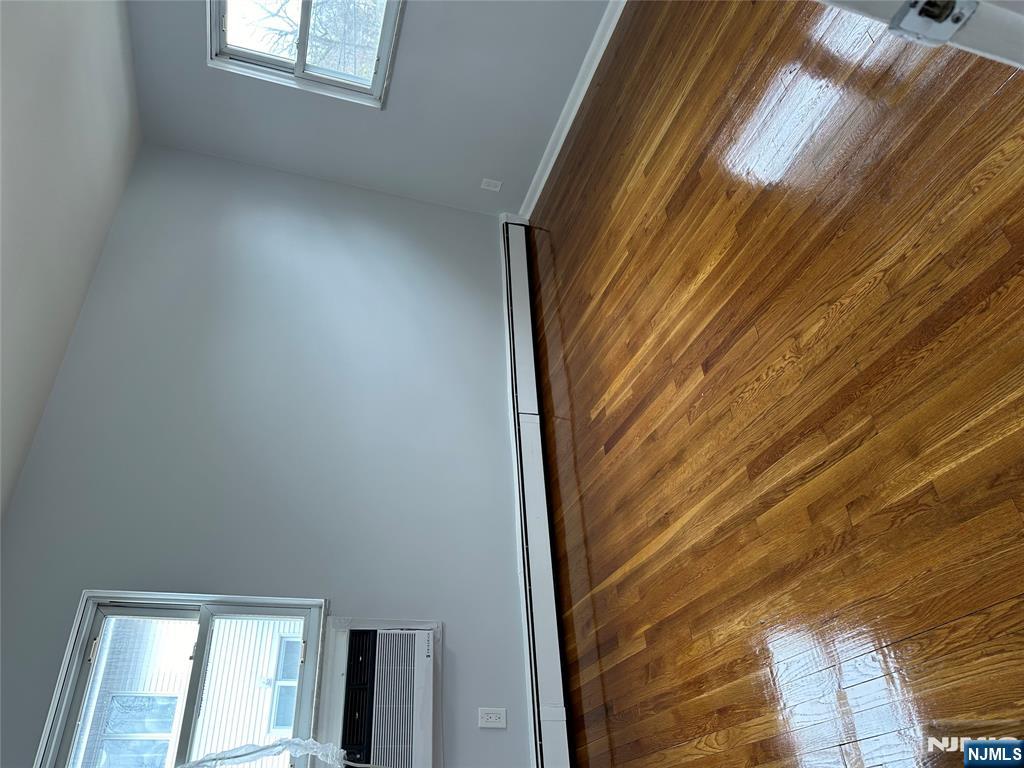 1032 Glen Road Fort Lee, NJ 07024 - Photo 14 of 16 a view of empty room with window and wooden floor