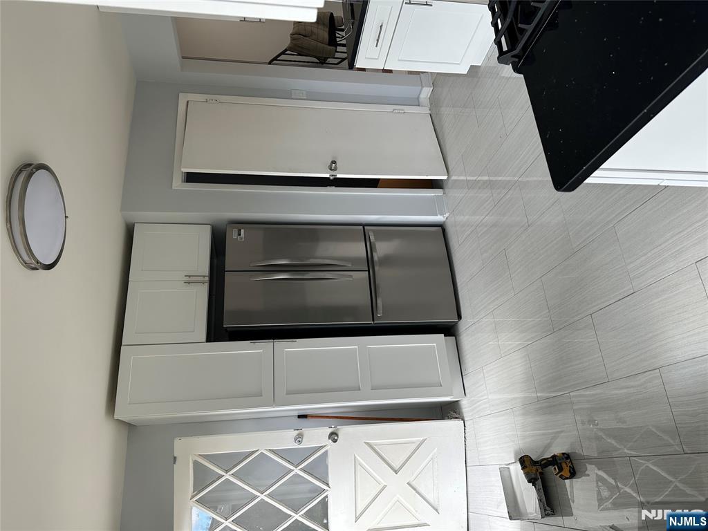 1032 Glen Road Fort Lee, NJ 07024 - Photo 8 of 16 a kitchen with stainless steel appliances a refrigerator sink and stove