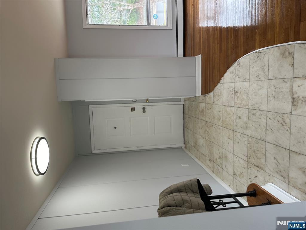 1032 Glen Road Fort Lee, NJ 07024 - Photo 9 of 16 a view of a livingroom with a chair and a window