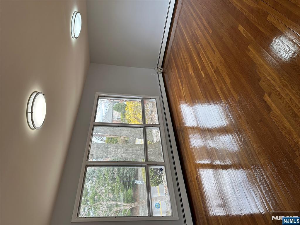 1032 Glen Road Fort Lee, NJ 07024 - Photo 10 of 16 a view of empty room with wooden floor and fan