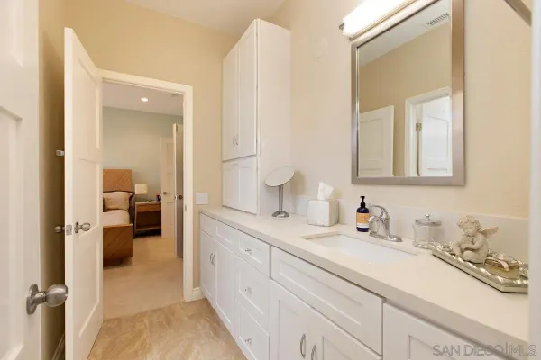 a en suite bathroom with a sink and mirror