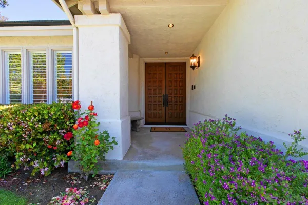 a house with a flower garden in front of it