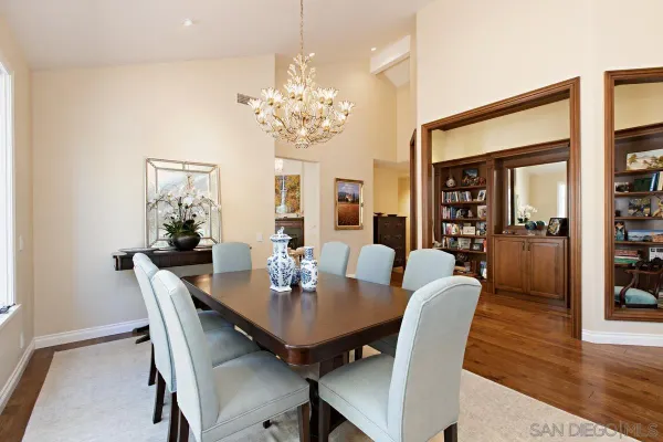 a view of a dining room with furniture wooden floor and chandelier