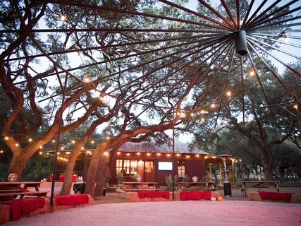 an aerial view of residential house with outdoor space and trees all around