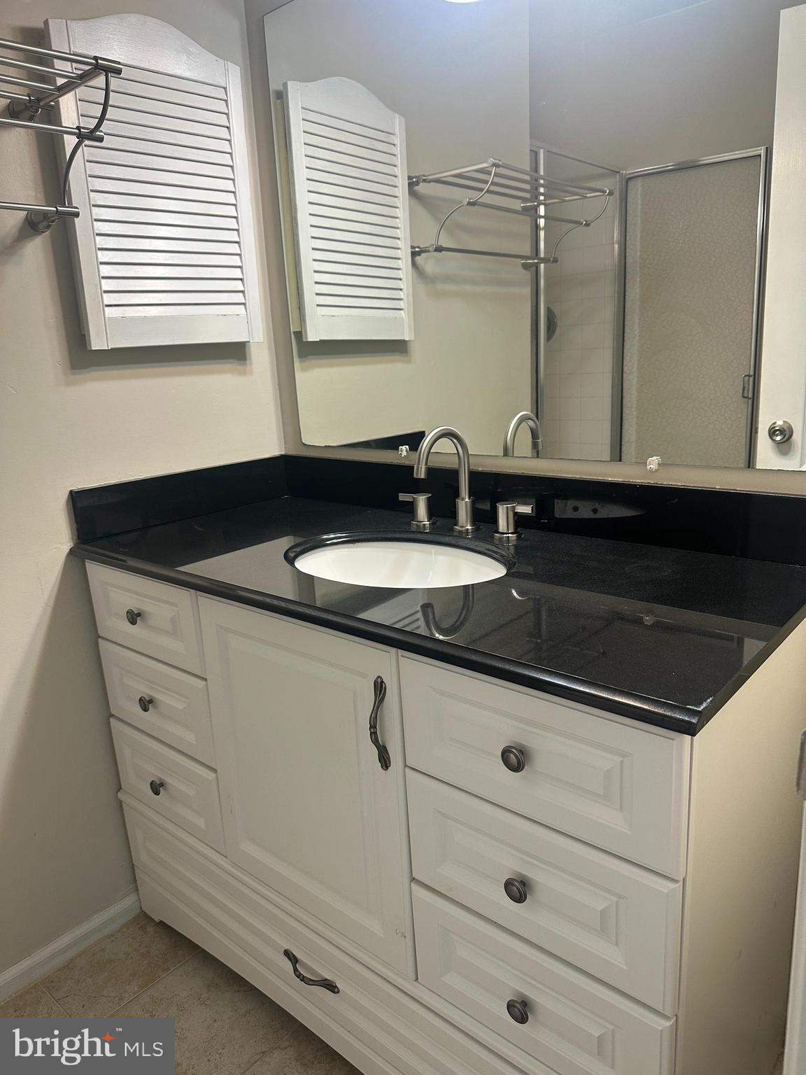 326 Lancaster Square, Unit 326 Sterling, VA 20164 - Photo 28 of 30 a bathroom with a sink and a mirror