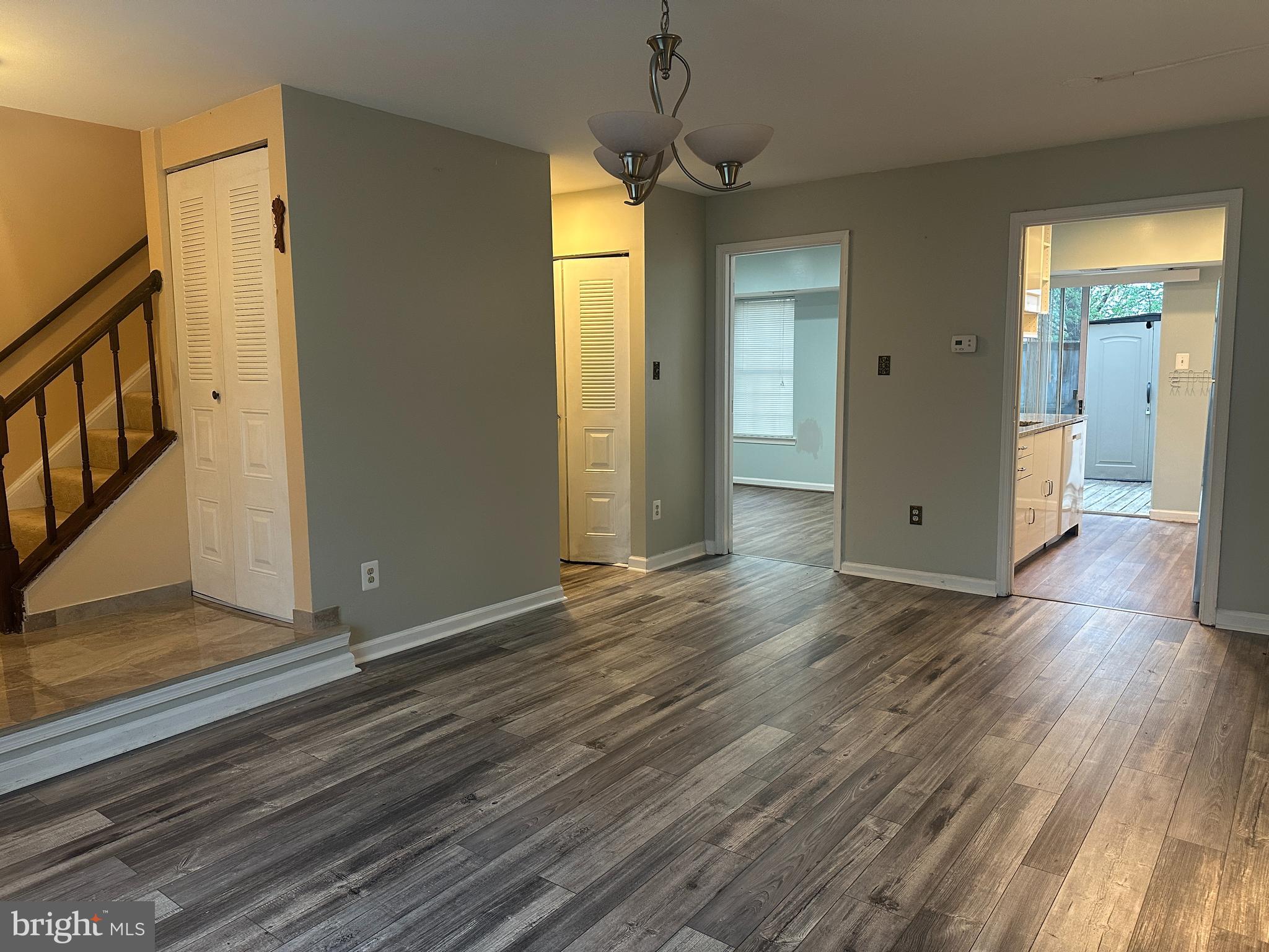 326 Lancaster Square, Unit 326 Sterling, VA 20164 - Photo 6 of 30 a view of an empty room with wooden floor and a window