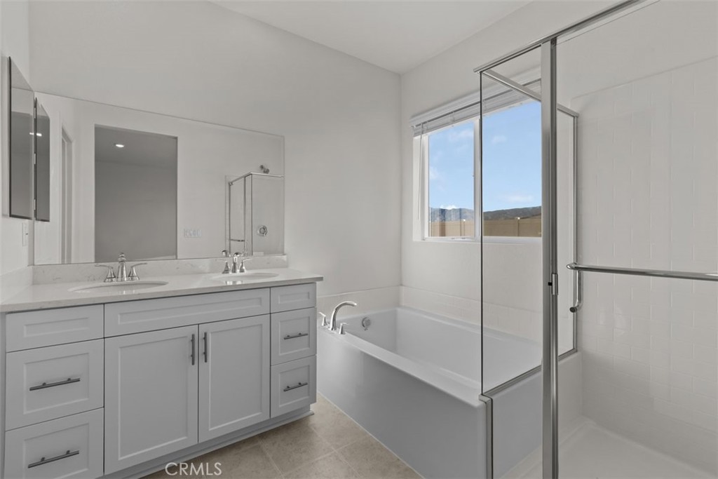 1218 Butterfly Way Banning, CA 92220 - Photo 11 of 16 a bathroom with a double vanity sink mirror and shower