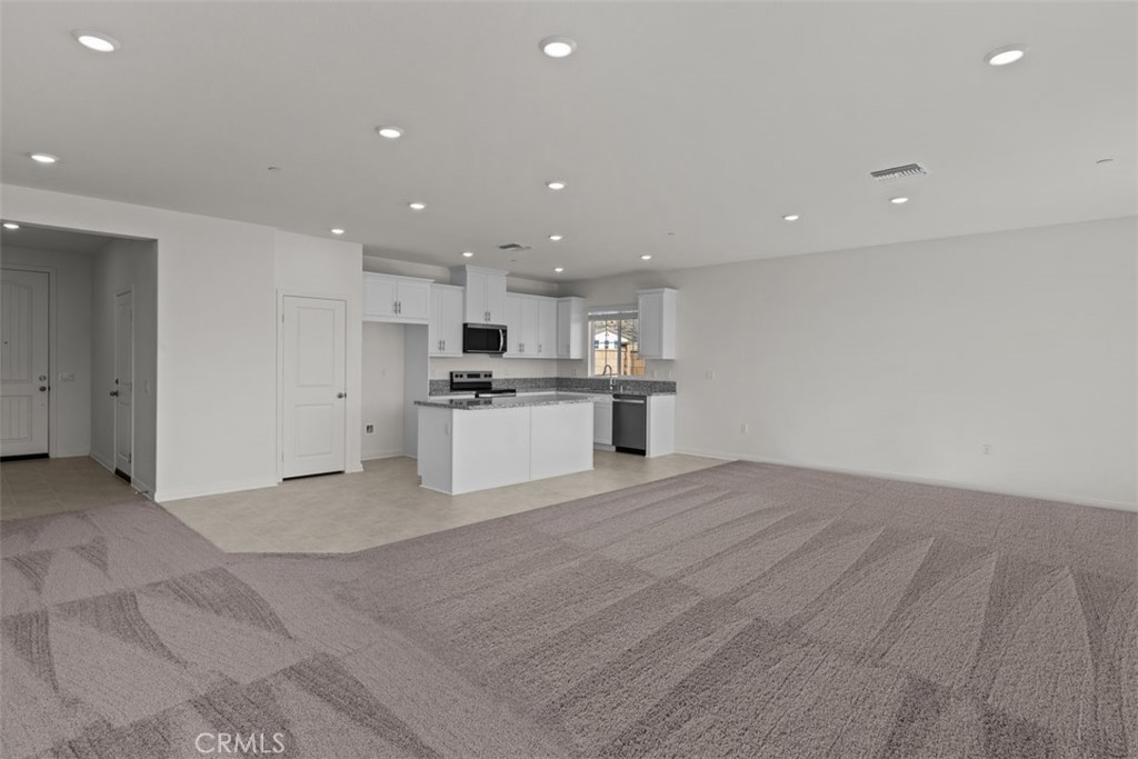 1218 Butterfly Way Banning, CA 92220 - Photo 2 of 16 a view of kitchen with granite countertop cabinets and refrigerator