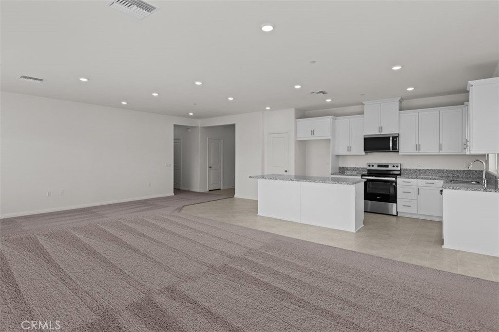 1218 Butterfly Way Banning, CA 92220 - Photo 3 of 16 a view of kitchen with granite countertop stainless steel appliances refrigerator and cabinets