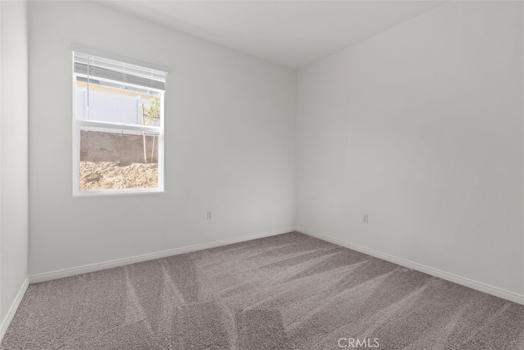 1218 Butterfly Way Banning, CA 92220 - Photo 8 of 16 an empty room with a window
