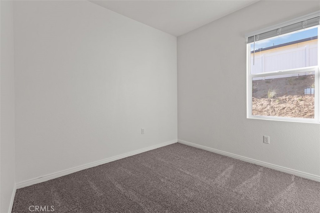 1218 Butterfly Way Banning, CA 92220 - Photo 9 of 16 an empty room with a window