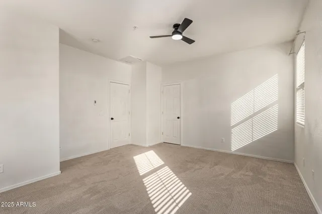 a view of room with a ceiling fan