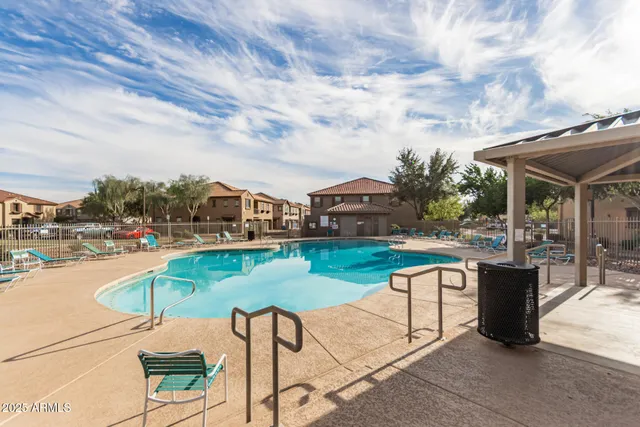 a roof deck with table and chairs a barbeque