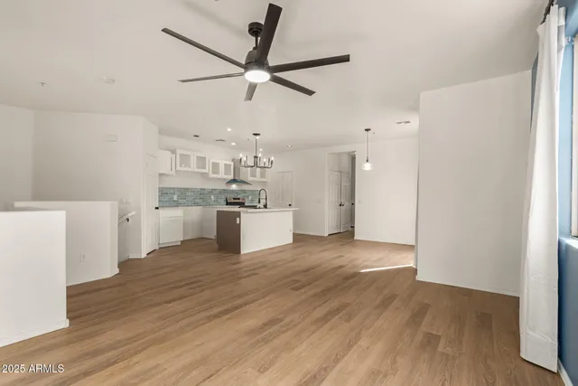 a view of a kitchen with a sink and wooden floor