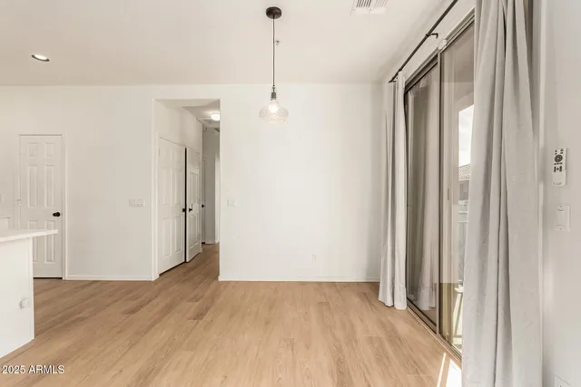 a view of a room with wooden floor and windows