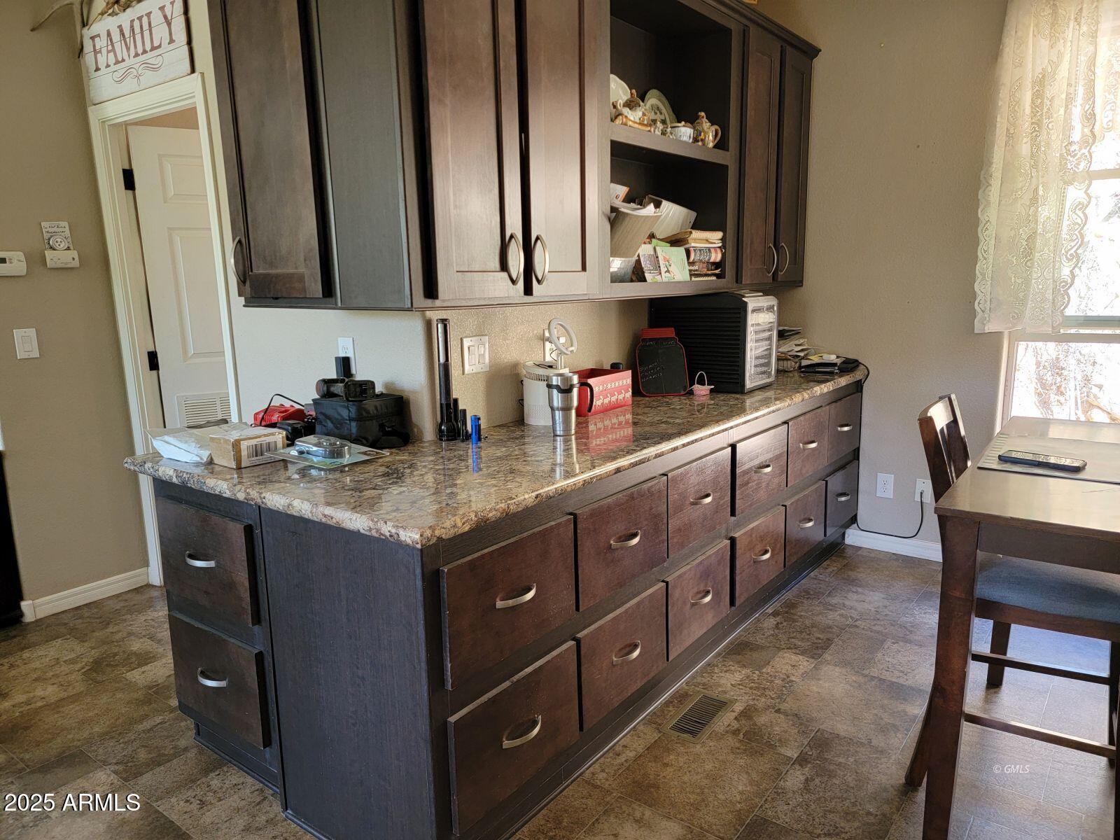 9383 Kellner Canyon Road Globe, AZ 85501 - Photo 11 of 32 a kitchen with granite countertop a sink stove and cabinets