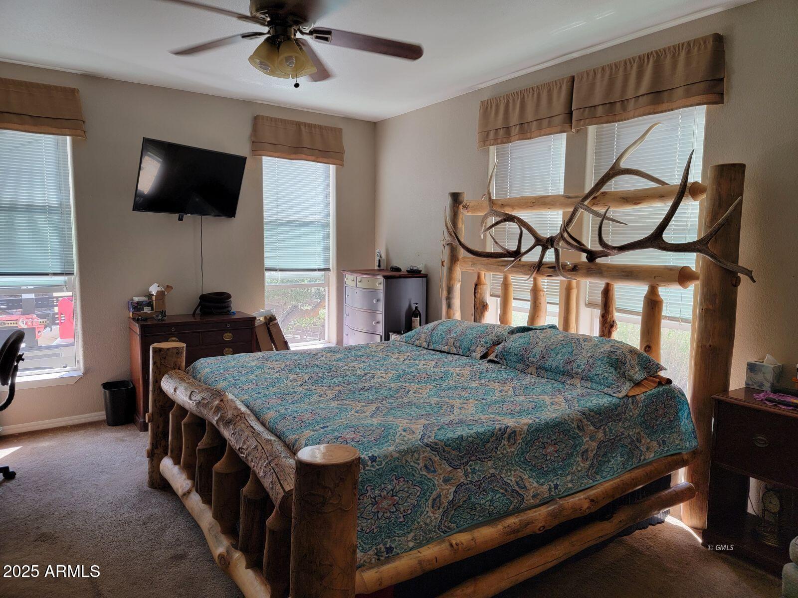 9383 Kellner Canyon Road Globe, AZ 85501 - Photo 15 of 32 a bedroom with a bed and a flat tv screen on the dresser