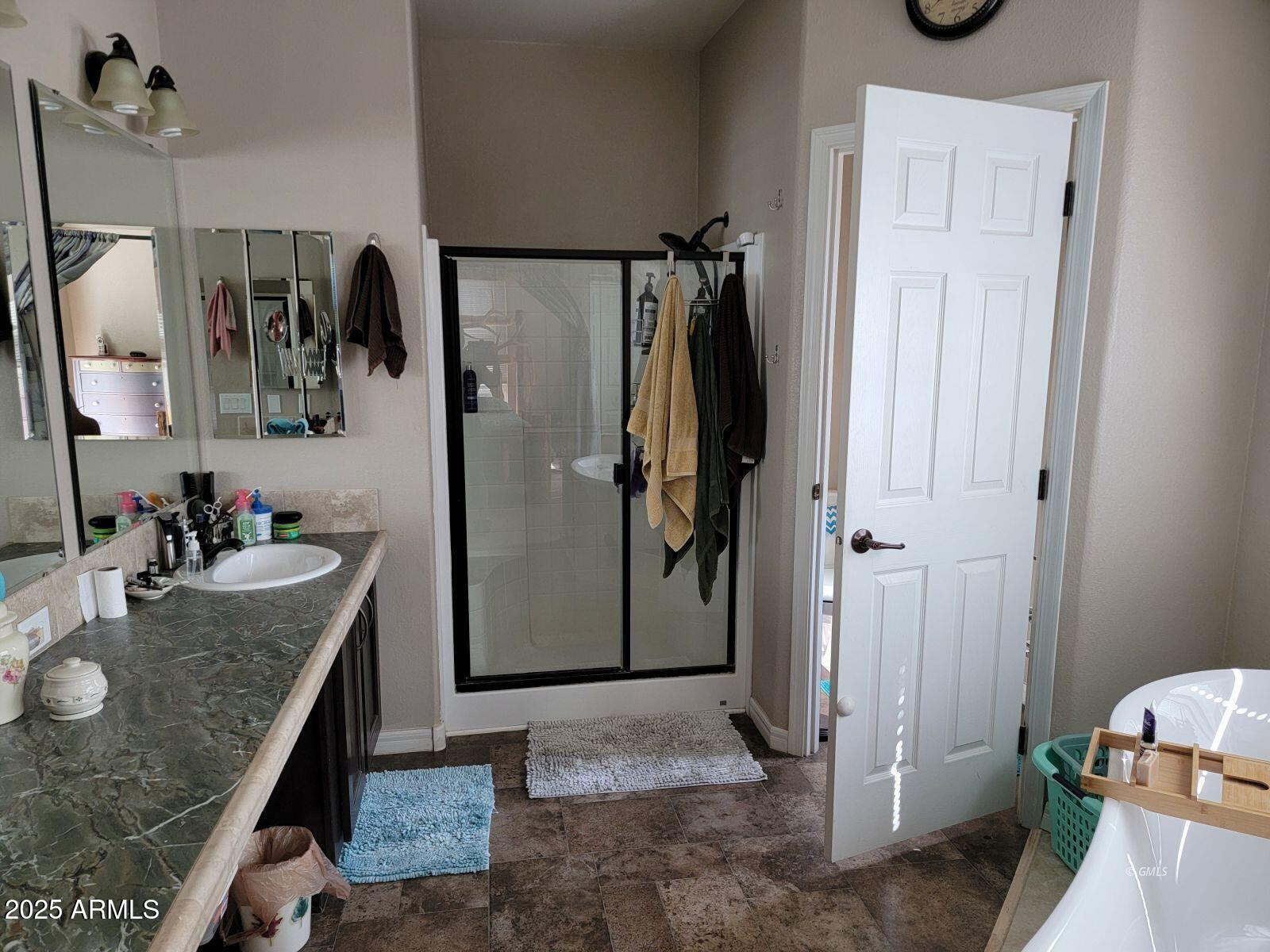 9383 Kellner Canyon Road Globe, AZ 85501 - Photo 18 of 32 a bathroom with a granite countertop shower a mirror and a sink