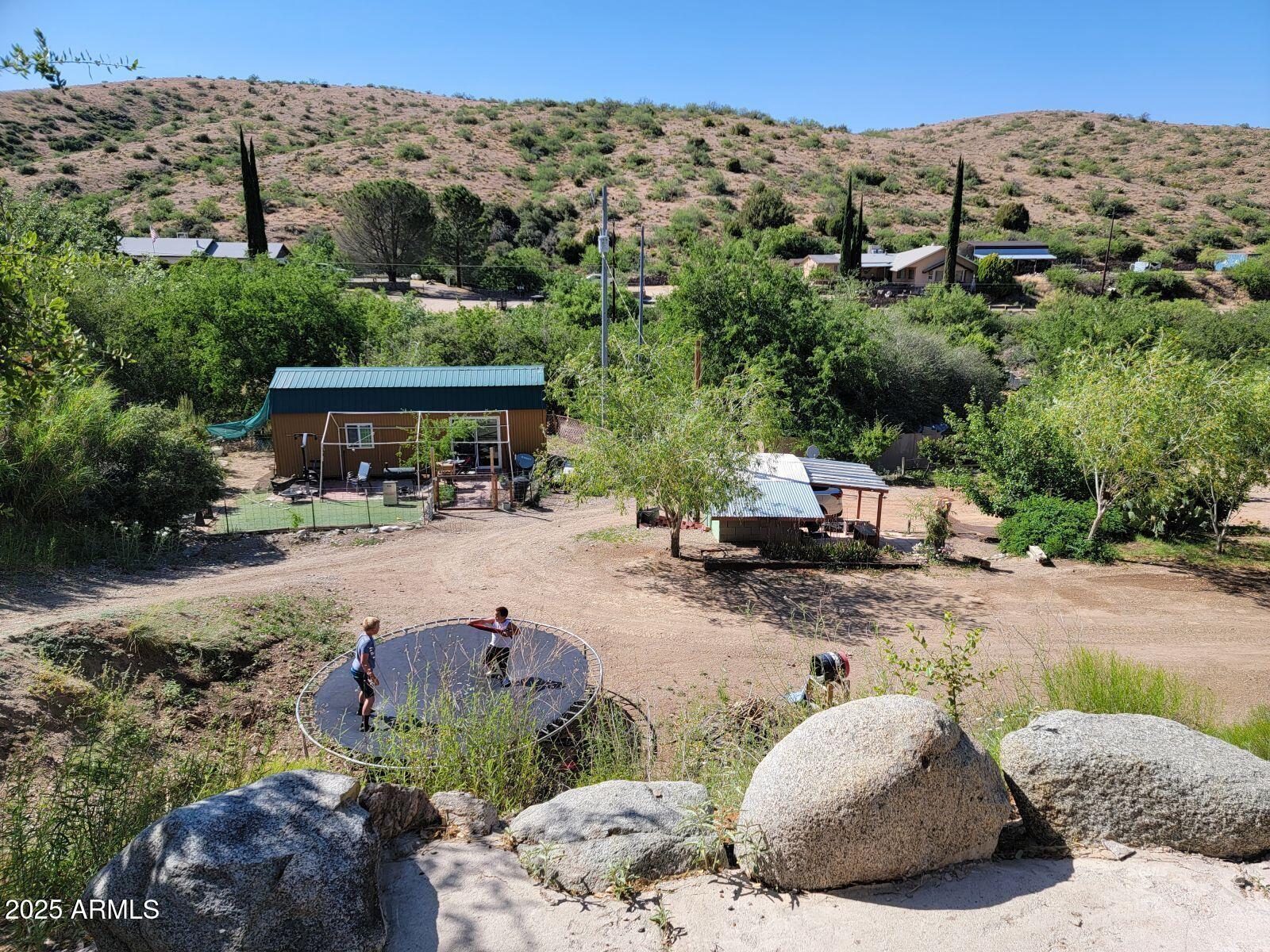 9383 Kellner Canyon Road Globe, AZ 85501 - Photo 20 of 32 a view of a patio with table and chairs under an umbrella
