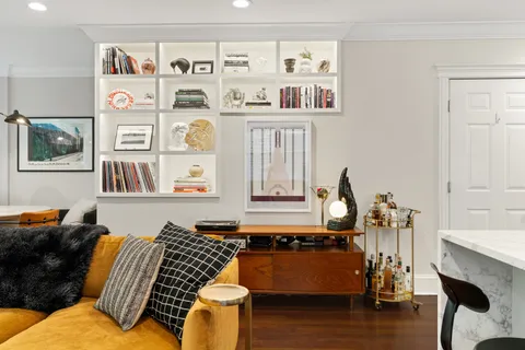 a living room with furniture fireplace and rug