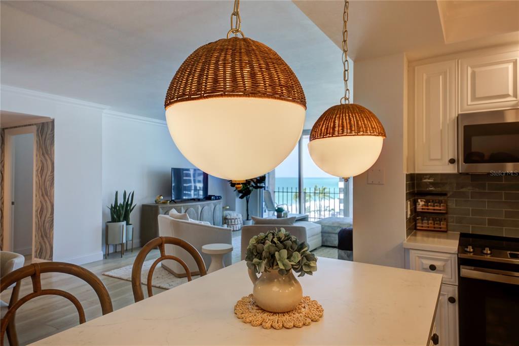 1212 Benjamin Franklin Drive, Unit 504 Sarasota, FL 34236 - Photo 17 of 48 a kitchen with a table a stove and a microwave