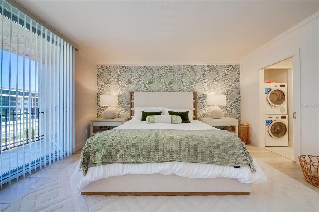 1212 Benjamin Franklin Drive, Unit 504 Sarasota, FL 34236 - Photo 20 of 48 a bedroom with a bed and wooden floor