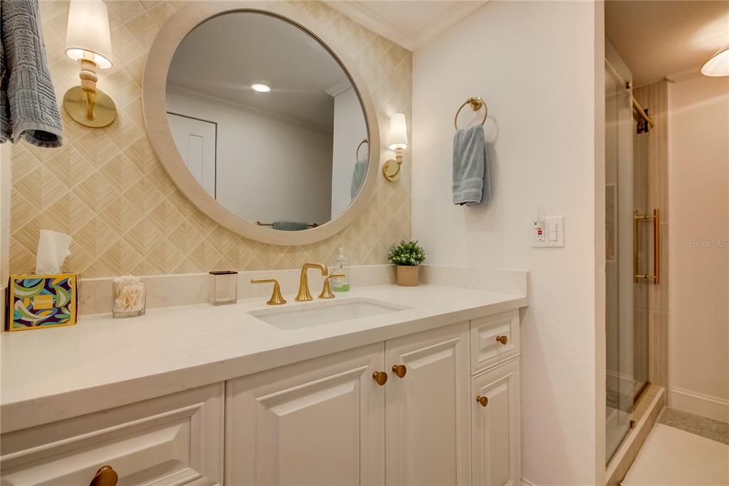 1212 Benjamin Franklin Drive, Unit 504 Sarasota, FL 34236 - Photo 23 of 48 a bathroom with a sink mirror and vanity