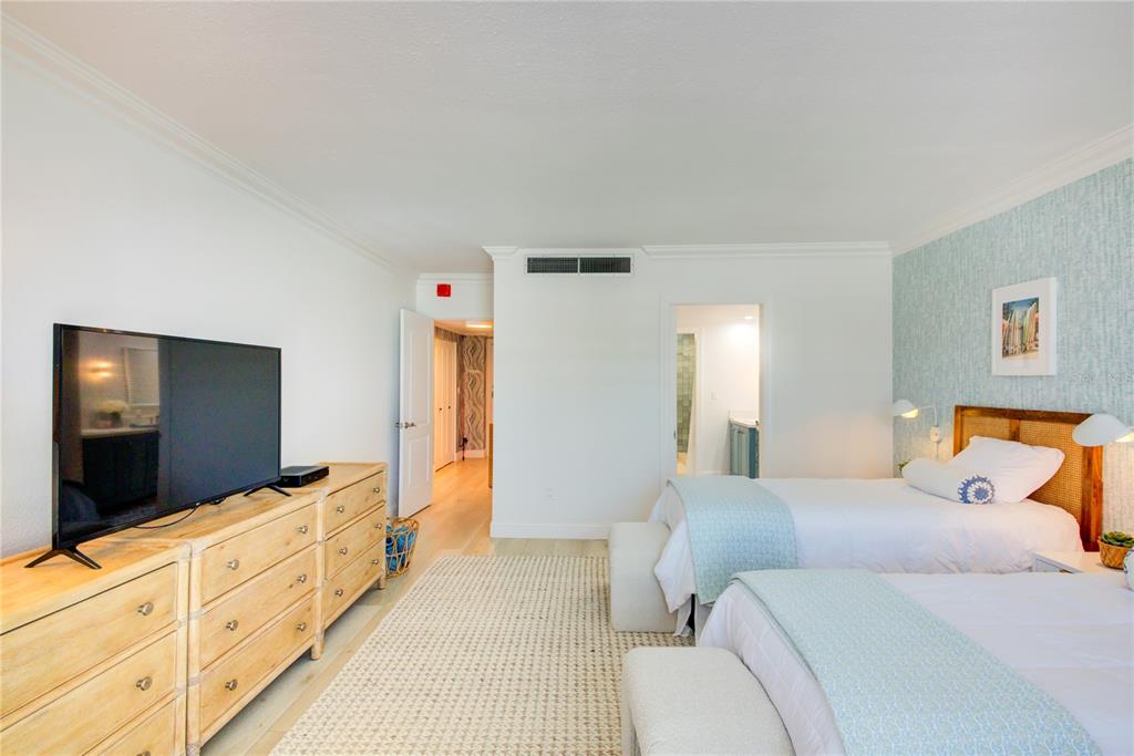 1212 Benjamin Franklin Drive, Unit 504 Sarasota, FL 34236 - Photo 25 of 48 a bedroom with furniture and a flat screen tv