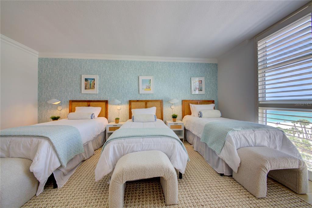 1212 Benjamin Franklin Drive, Unit 504 Sarasota, FL 34236 - Photo 27 of 48 a bedroom with two beds and a couch