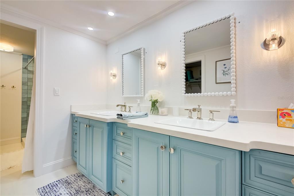 1212 Benjamin Franklin Drive, Unit 504 Sarasota, FL 34236 - Photo 29 of 48 a bathroom with a sink and a mirror