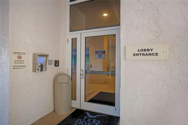 a view of a hallway with windows and stairs