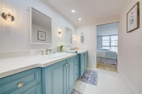 a living room with furniture a rug and kitchen view