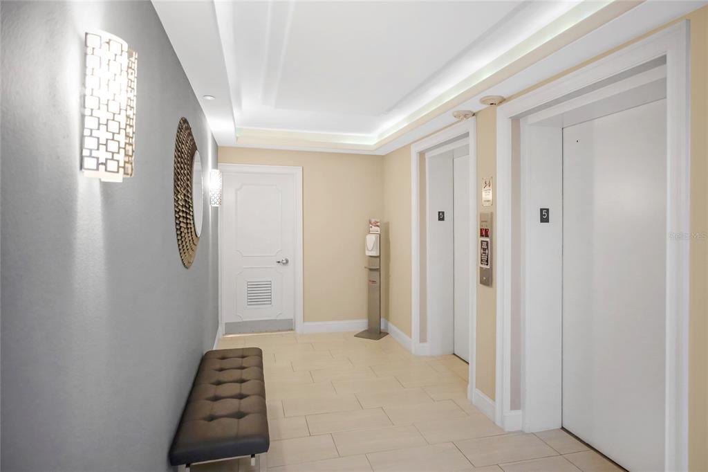 1212 Benjamin Franklin Drive, Unit 504 Sarasota, FL 34236 - Photo 4 of 48 a view of a hallway with windows and stairs