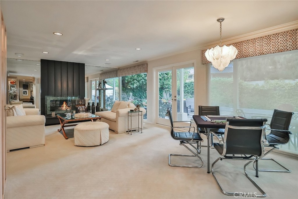 4575 De Celis Place Encino, CA 91436 - Photo 11 of 63 a living room with fireplace furniture and a chandelier