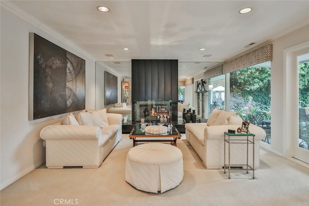 4575 De Celis Place Encino, CA 91436 - Photo 13 of 63 a living room with furniture and large windows