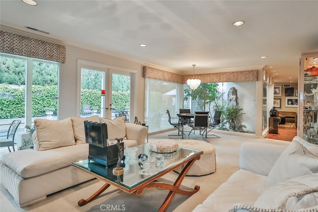 4575 De Celis Place Encino, CA 91436 - Photo 14 of 63 a living room with furniture and large windows