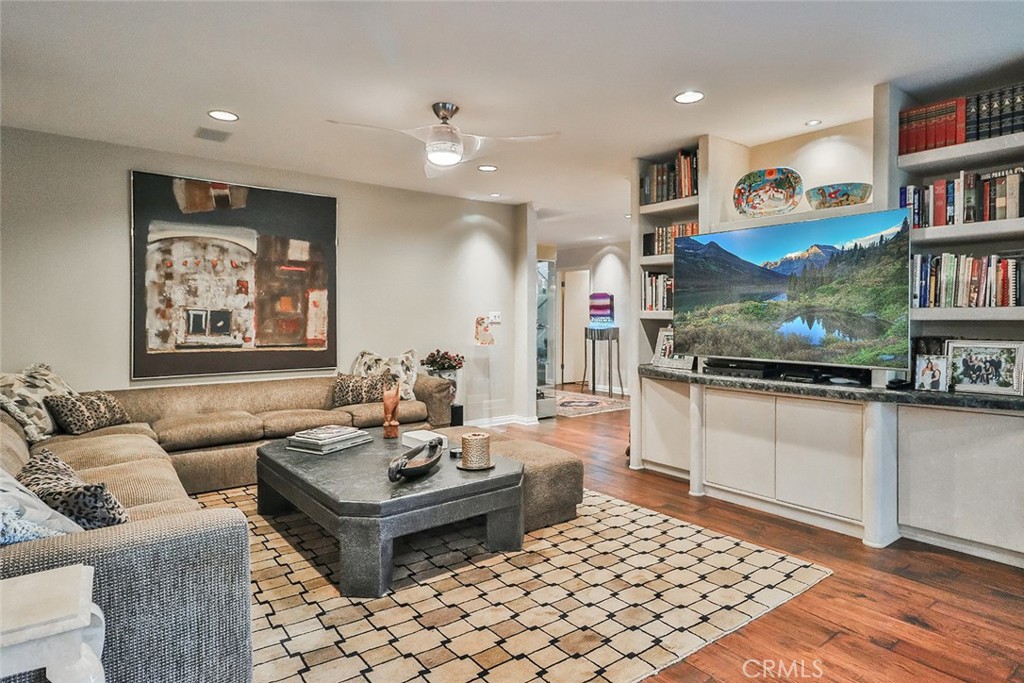 4575 De Celis Place Encino, CA 91436 - Photo 17 of 63 a living room with furniture and a book shelf