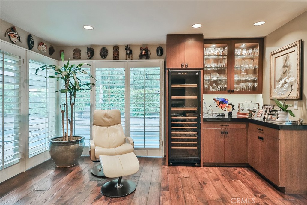 4575 De Celis Place Encino, CA 91436 - Photo 18 of 63 a hallway with a kitchen island furniture and a wooden floor