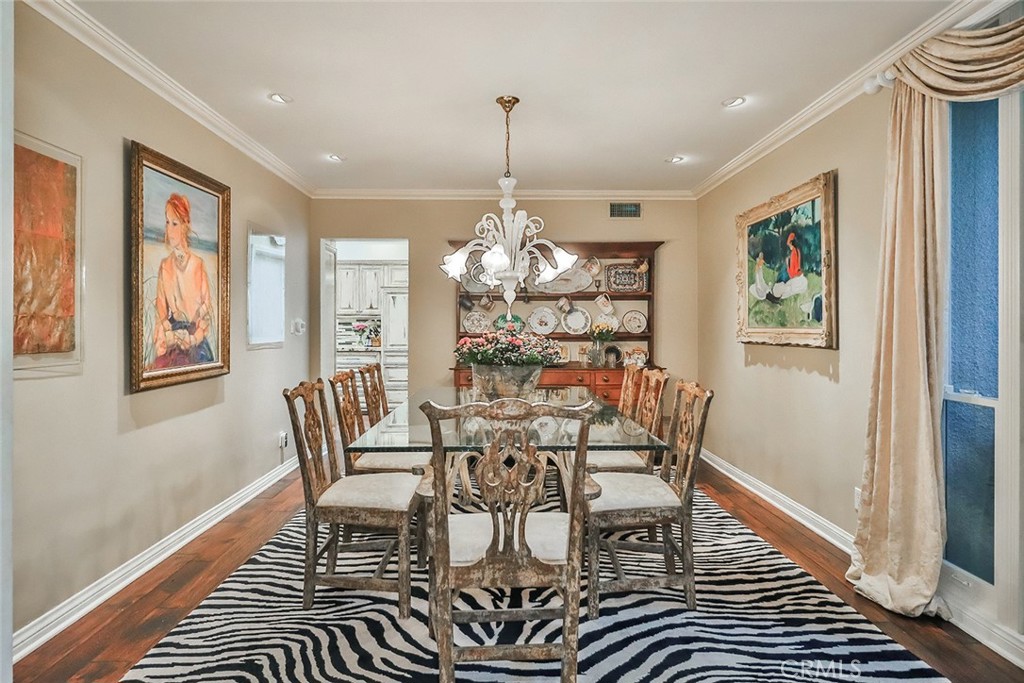 4575 De Celis Place Encino, CA 91436 - Photo 19 of 63 a dining room with furniture a chandelier and wooden floor