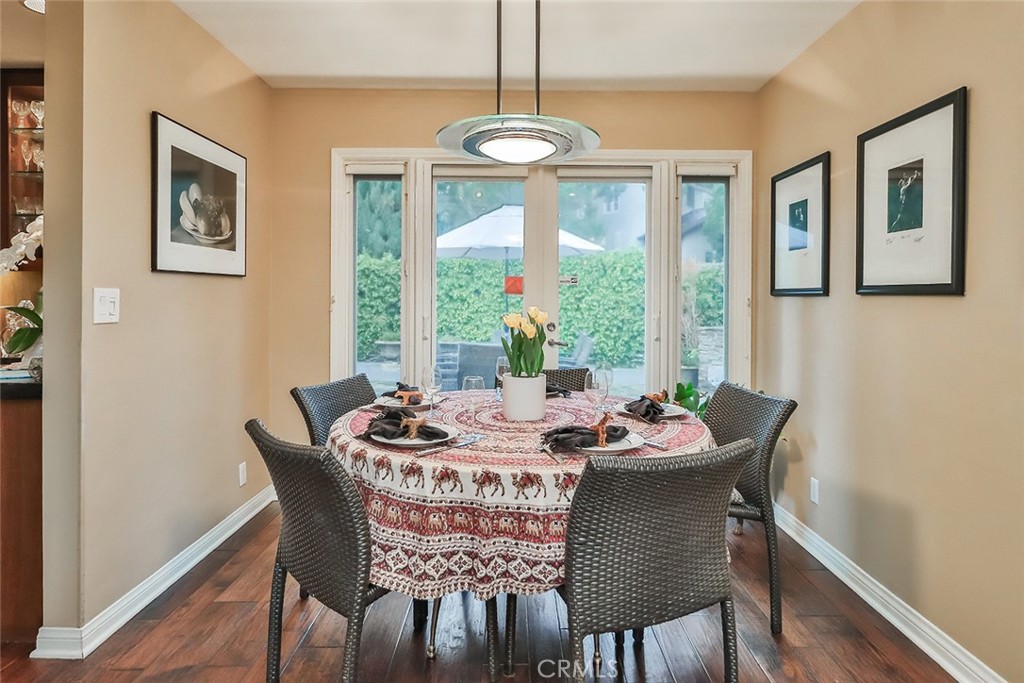 4575 De Celis Place Encino, CA 91436 - Photo 21 of 63 a dining room with furniture a chandelier and wooden floor