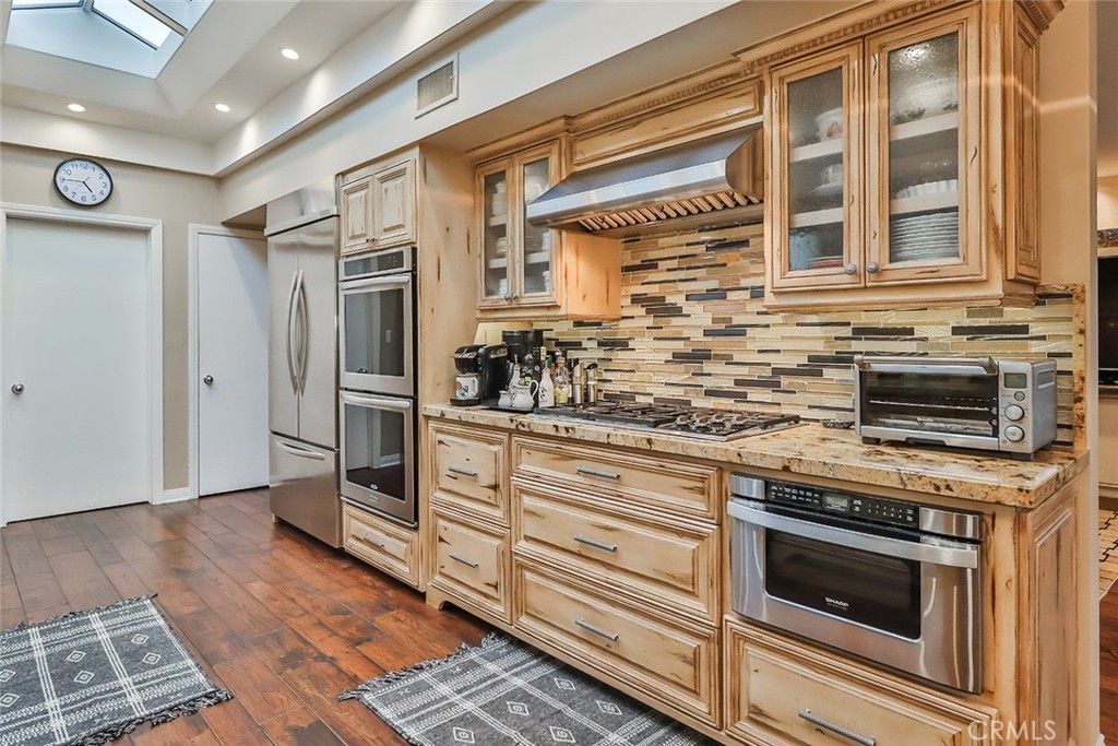 4575 De Celis Place Encino, CA 91436 - Photo 25 of 63 a kitchen with granite countertop a stove and a sink