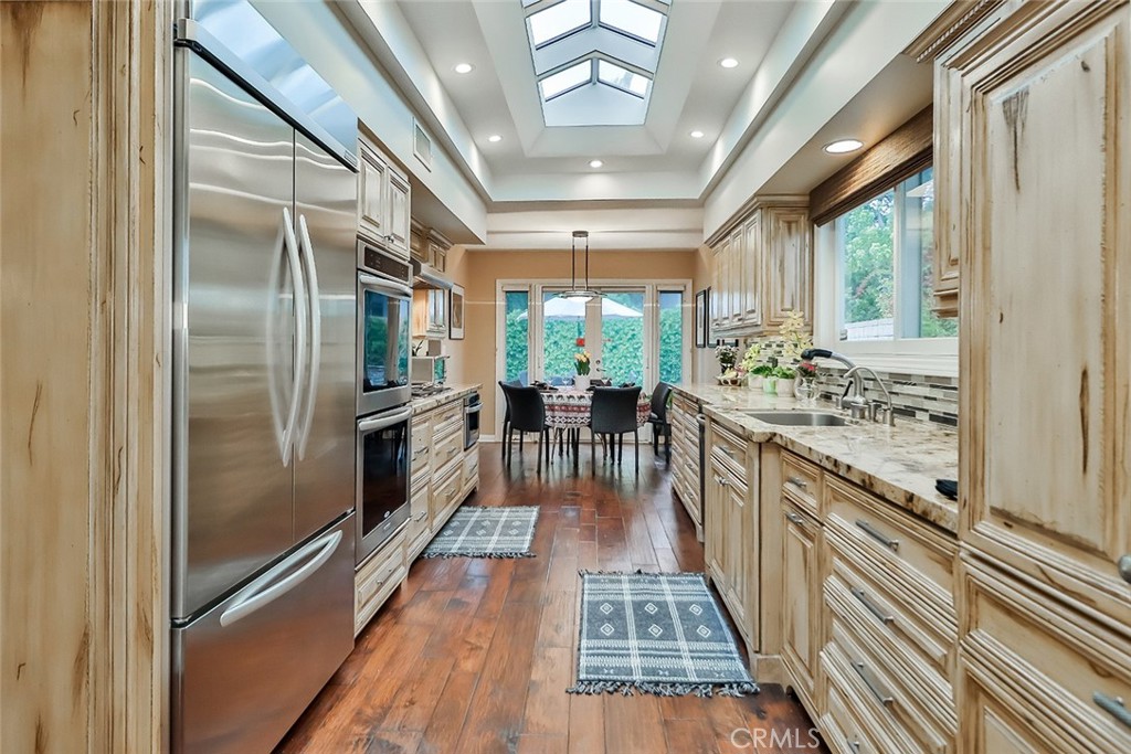 4575 De Celis Place Encino, CA 91436 - Photo 28 of 63 a kitchen with counter top space and stainless steel appliances